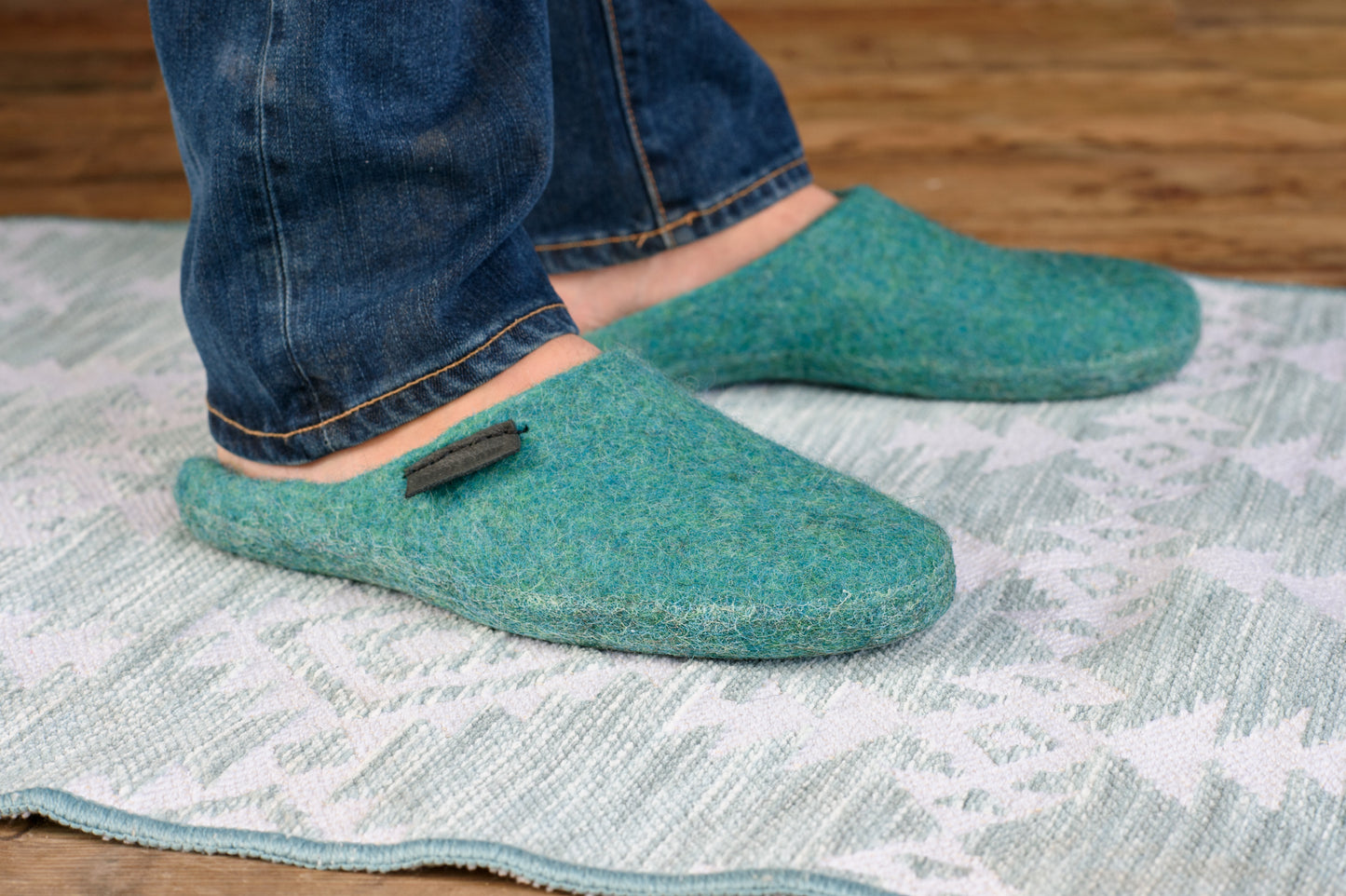 Green Turquoise closed toe slippers on mens feet, Men is standing on the patterned rug
