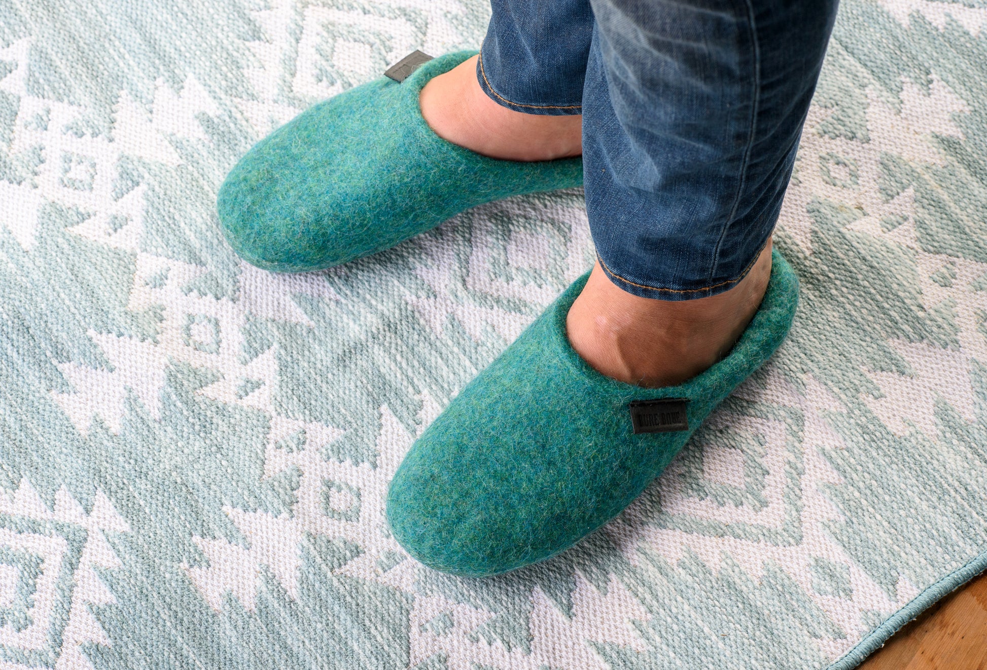 Man with jeans is wearing blue lagoon backless closed toe slippers