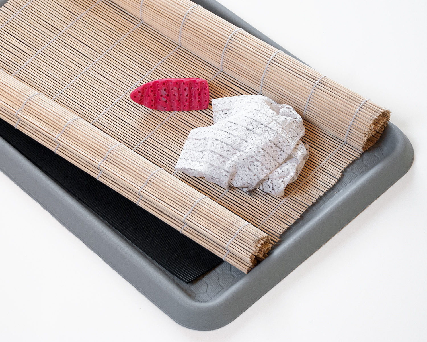 Tools for wet felting: a plastic felting tool, a bamboo mat, a tray