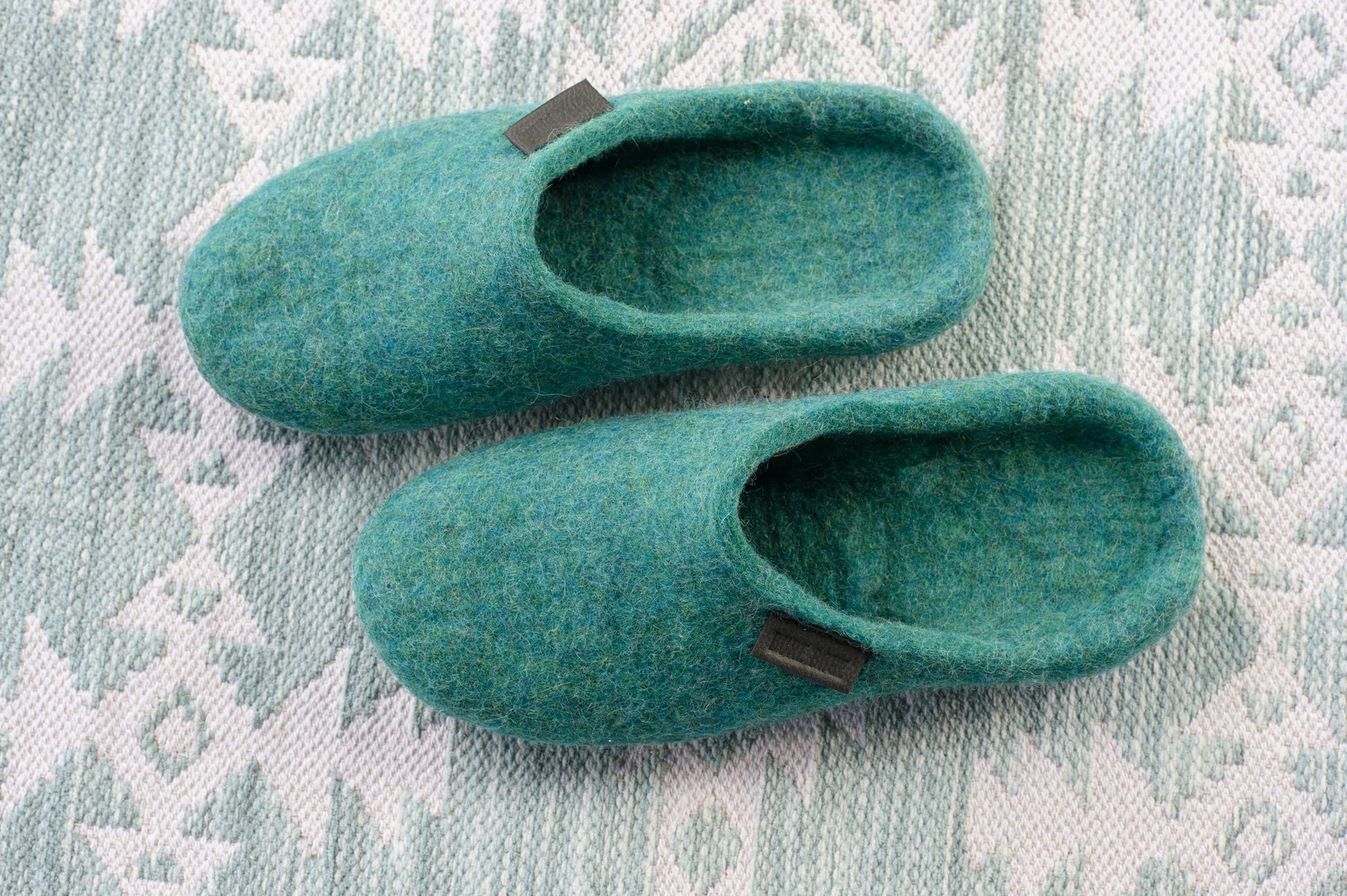 Flat Lay photo of Handmade Wool Slippers for Women on a patterned tablecloth