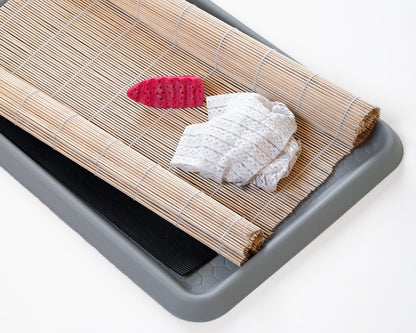 Tools for wet felting: a plastic felting tool, a bamboo mat, a tray 